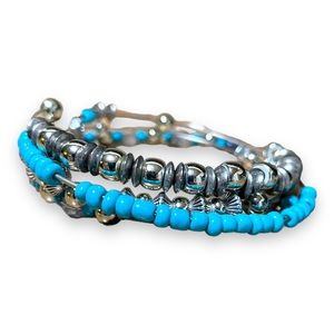 4 silver bracelets with silver and blue beading.